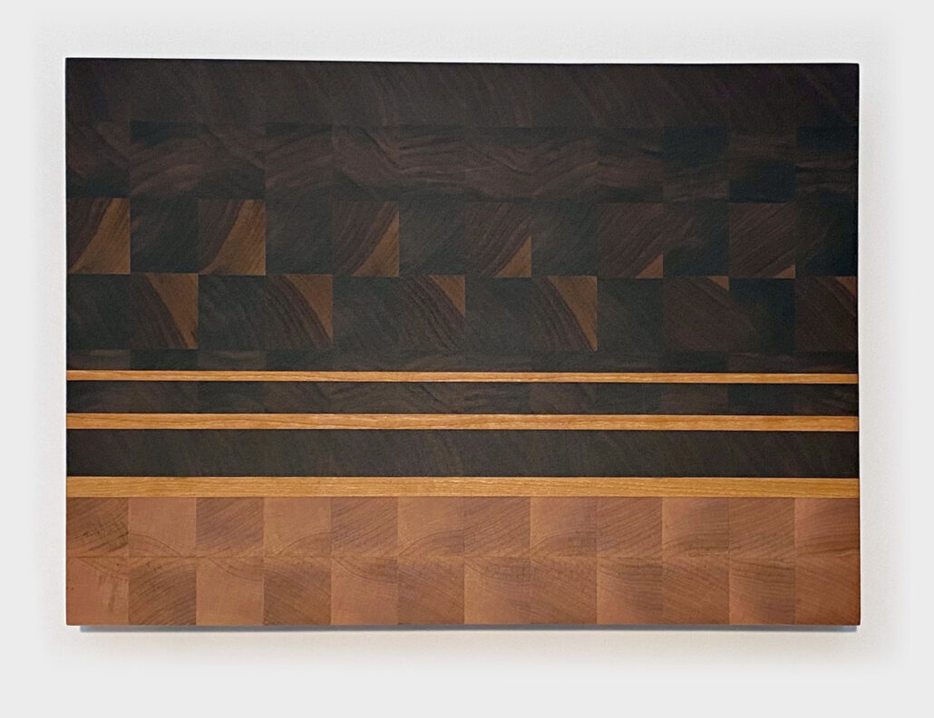 Oversized walnut and maple end grain cutting board with cherry accents and finger groove